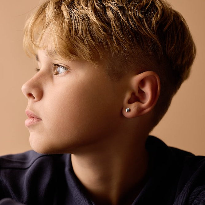 Oorbellen Blomdahl titanium goudkleurig knopje 5 mm. aqua zirconiasteentje