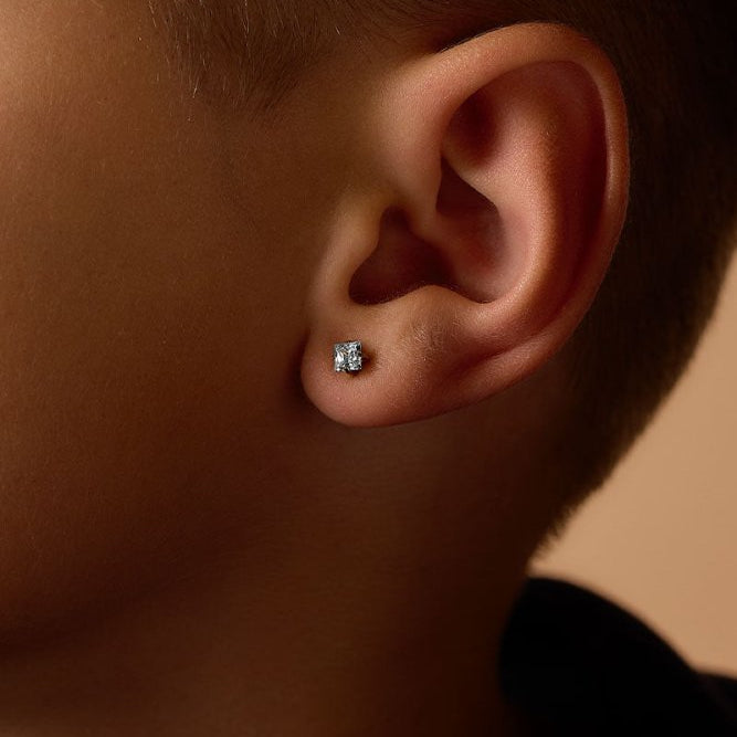 Oorbellen Blomdahl titanium goudkleurig knopje 5 mm. aqua zirconiasteentje